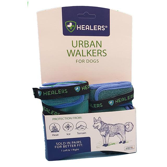 Healers Urban Walker III Waterproof Dog Boots in teal and blue are displayed in their retail box, which highlights features such as protection from heat, ice, and terrain. The box also shows the Healers logo and a husky dog illustration, and states the boots are sold in pairs.