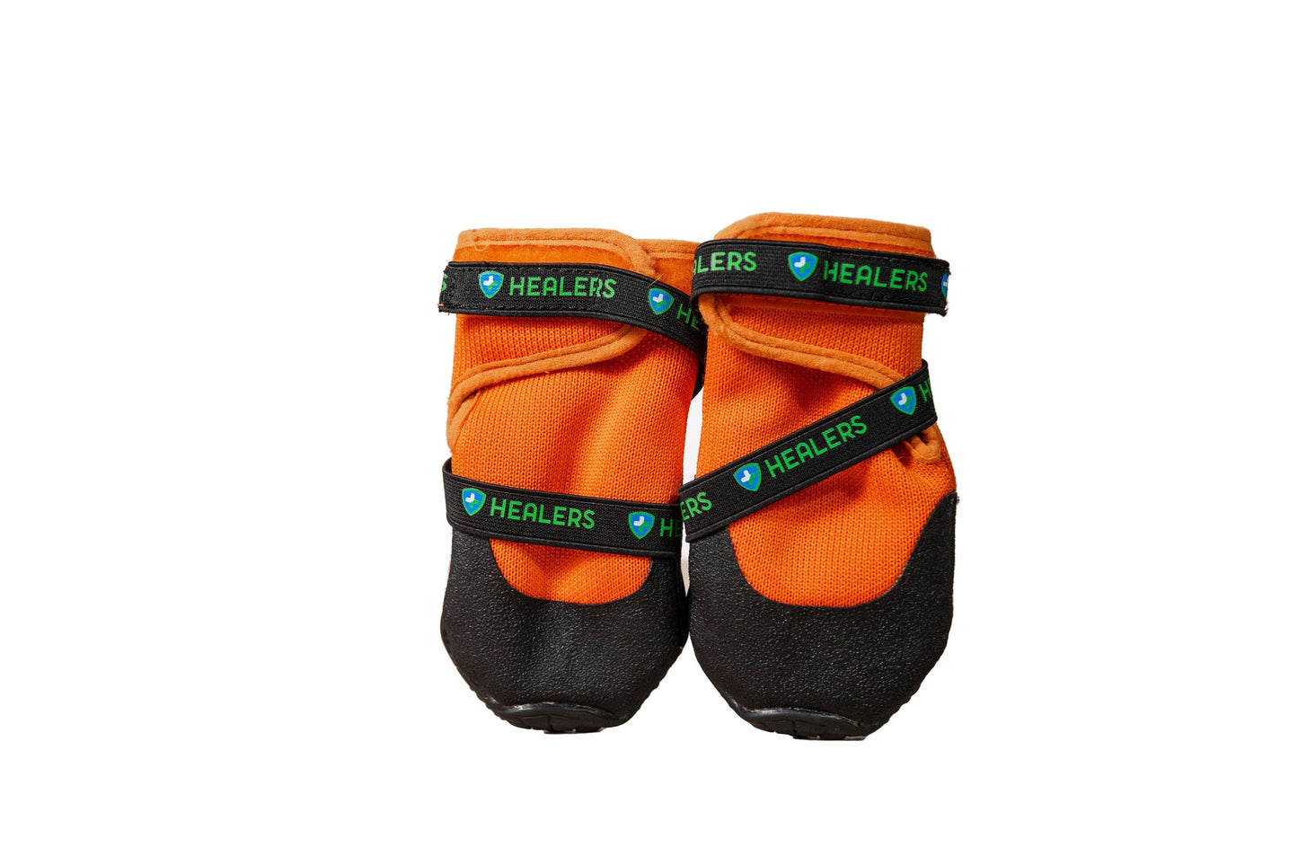 Pair of orange Healers dog boots with black non-slip soles and adjustable branded straps for secure paw protection